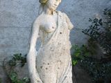 a statue of a woman holding a flower in her hand