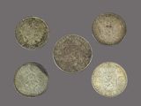 a group of five different british coins