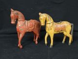 these are two wooden horses that are standing next to each other