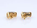 a pair of gold and diamond earrings
