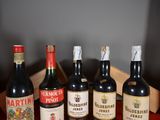 several bottles of wine are lined up in a row on a table