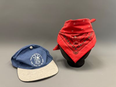 two hats and a bandana are sitting on top of a hat