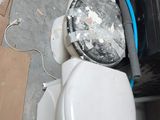 a pile of toilet bowls and other items on the floor