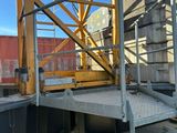 a construction worker standing on a scaffolding platform