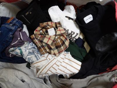 a red suitcase filled with clothes and a pair of shoes