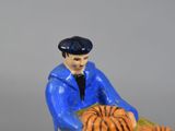 a figurine of a man sitting on a tiger