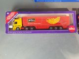 a toy truck that is in a box on the table