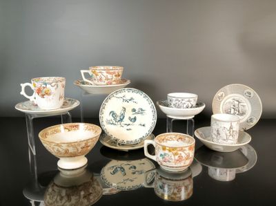 many cups and saucers that are sitting on a table