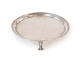 a silver plate on a stand on a white background