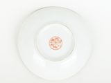 a white plate with a red flower on it