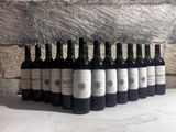 bottles of wine lined up in a row on a table