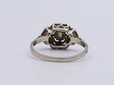 a close up of a ring with a brown stone in it