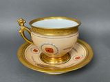 a cup and saucer on a saucer on a table