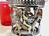 a silver vase with a horse and rider on it