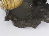 a statue of a bird sitting on top of a vase