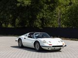 a white sports car that is parked in a parking lot