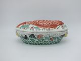 an image of a ceramic box with a fish design on it