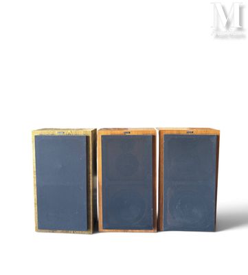 three speakers are sitting side by side on a white surface