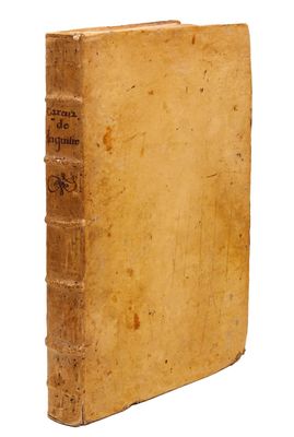 an old book sitting on top of a white surface
