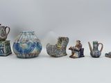 many different types of vases sitting on a white surface