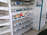 a white shelf with shelves on it in a store