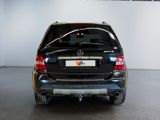 a picture of a black mercedes suv parked in a garage