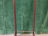 an image of a metal rack with a green curtain in the background