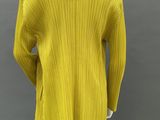 a mannequin mannequin wearing a yellow sweater and black pants