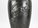 a black vase with a dragon on it on a white background