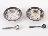 two spoons and a spoon rest on a white surface