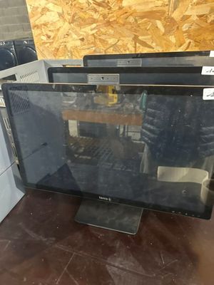 two computer monitors sitting on top of a table next to each other