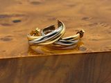 pair of gold and silver rings sitting on top of a wooden box