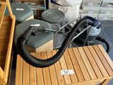 a wooden table with a vacuum on top of it
