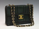 a close up of a black purse with a chain around it