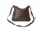 a brown and black purse sitting on top of a white surface