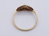 a close up of a gold ring with a leaf design on it