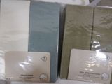 several folded towels are sitting on a table in a box