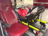 a red seat in the back of an ambulance