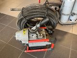 a machine that is sitting on the floor with a hose
