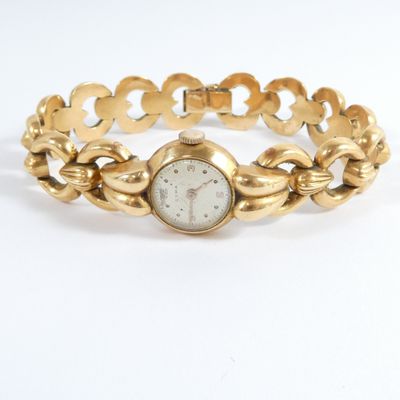an image of a woman ' s gold bracelet watch with a white dial