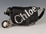 black shoulder bag with silver letters and a chain