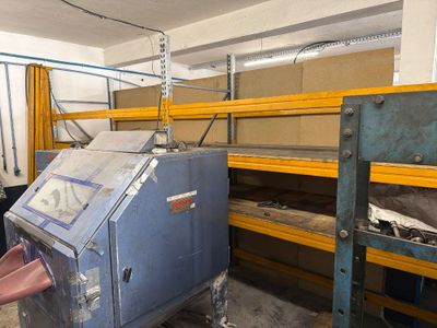 a machine that is sitting in a room with shelves