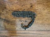 a metal handle that is on a wooden table