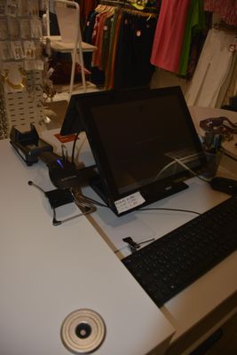 a laptop computer sitting on top of a white desk
