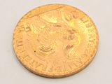 a gold coin with a picture of a woman on it