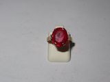 an image of a ring with a red stone on it