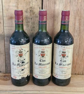 three bottles of wine sitting on top of a wooden table