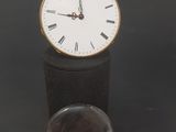a small clock that is sitting on top of a table