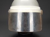 an image of a helmet on a stand on a black surface