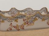 a glass bowl with a floral design on it on a table